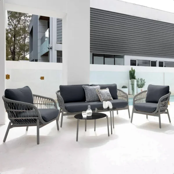 Outdoor garden 4-seater rope sofa with light grey cushions and dark grey woven rope frame placed on a patio.