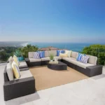 L-shape outdoor wicker patio sectional set with cream cushions and matching coffee table in dark brown