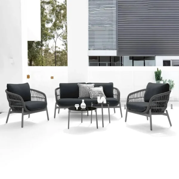 Outdoor garden 4-seater rope sofa with light grey cushions and dark grey woven rope frame placed on a patio.