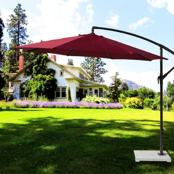 9-foot red offset cantilever patio umbrella with marble base and crank handle in a backyard setting