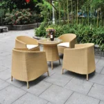 5-piece beige and white rattan patio conversation set with sofa, chairs, and table