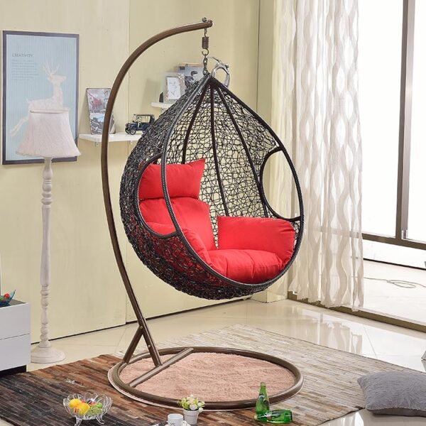 Single seater hanging swing with a sturdy black metal stand, ideal for balcony or garden seating.