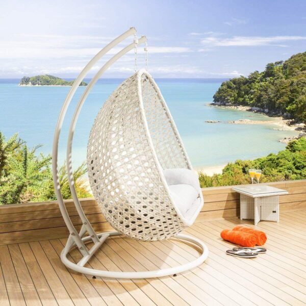 Double seater hanging swing chair in white with soft cushions, placed in a modern outdoor setting.