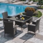 5-piece outdoor rattan dining set with grey cushions and dark brown armchairs, perfect for patio or garden