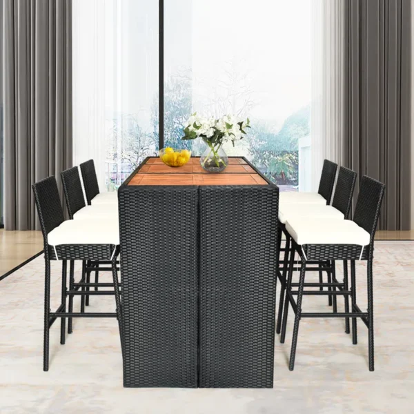 7-piece outdoor rattan bar set in black and off-white with high stools, table, and cushions, perfect for garden or patio settings.