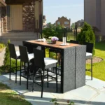 7-piece outdoor rattan bar set in black and off-white with high stools, table, and cushions, perfect for garden or patio settings.