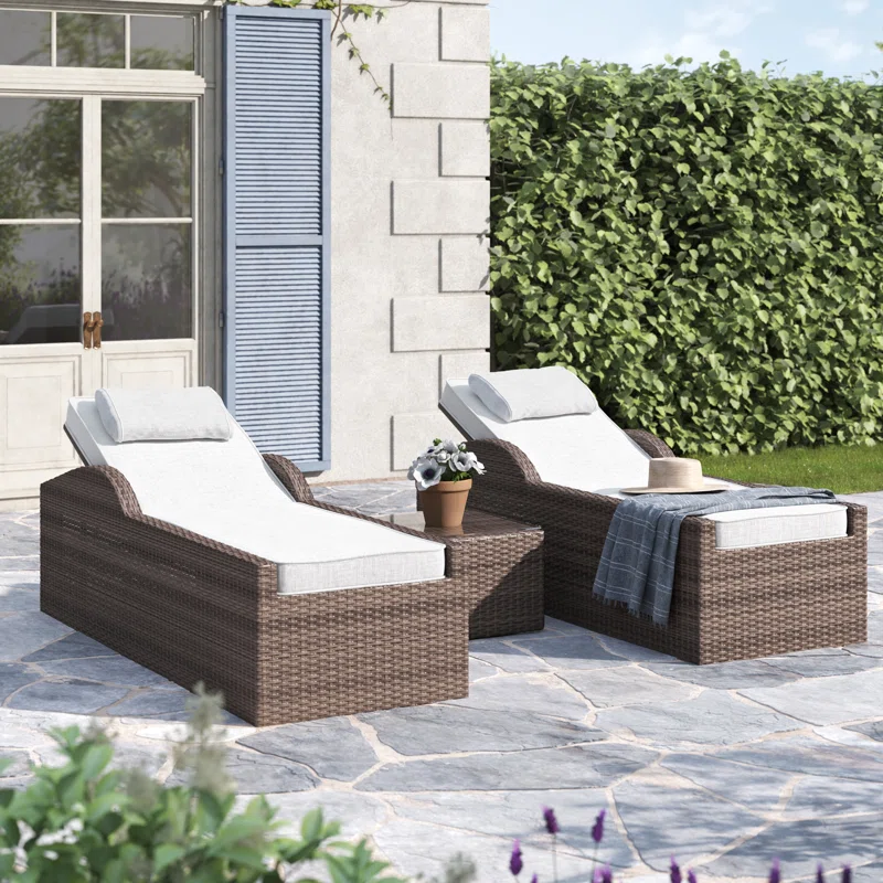 Rattan wicker long reclining outdoor chaise lounge in brown and off-white with cushions.