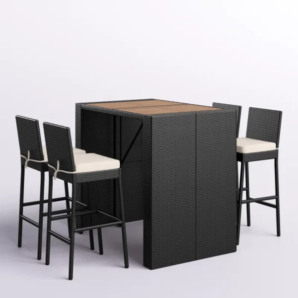 5 piece outdoor patio rattan bar set in black and white with high chairs and a bar table arranged on a garden patio.