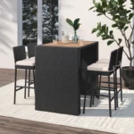 5 piece outdoor patio rattan bar set in black and white with high chairs and a bar table arranged on a garden patio.