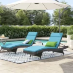 Set of 2 outdoor patio recliner lounger chairs in dark brown frame with sky blue all-weather cushions.
