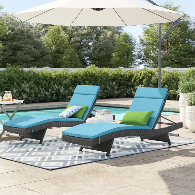 Set of 2 outdoor patio recliner lounger chairs in dark brown frame with sky blue all-weather cushions.