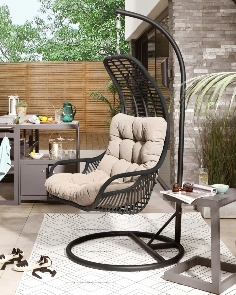 Single seater hanging swing with stand in black and beige, perfect for balcony or garden relaxation.