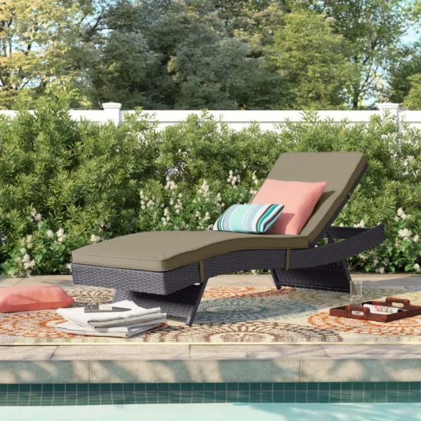 Beige wicker rattan outdoor patio chaise lounge chair with cushioned seat.
