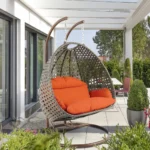 Double seater swing with unique design in dark brown frame and orange cushions, perfect for indoor or outdoor use