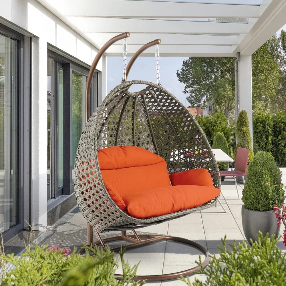 Double seater swing with unique design in dark brown frame and orange cushions, perfect for indoor or outdoor use