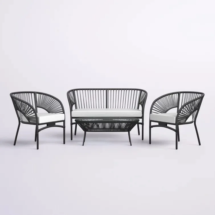 4-seater outdoor rope sofa set in black and white with a matching center table placed on a patio.