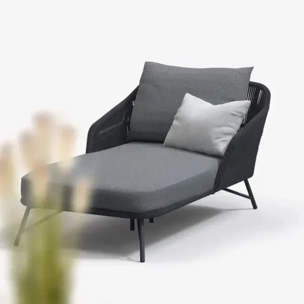 Grey rope daybed set with round outdoor sofa, matching side table, and sun lounger on patio