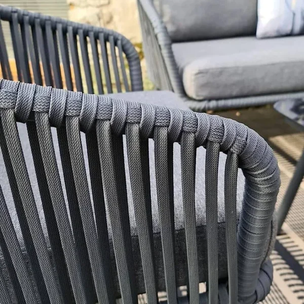 Grey 4 seater rope sofa set with cushions placed in a modern outdoor setting