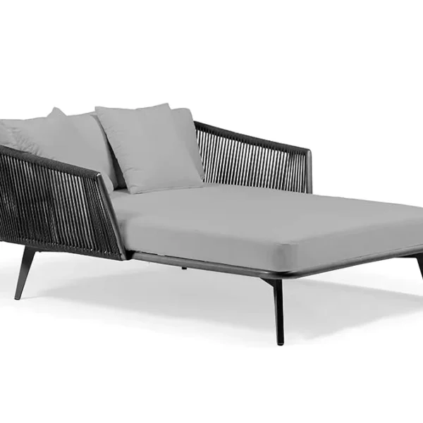 Black and grey patio rope daybed set with cushions placed outdoors on a wooden deck surrounded by greenery.