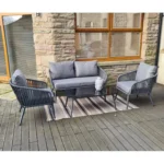 Grey 4 seater rope sofa set with cushions placed in a modern outdoor setting
