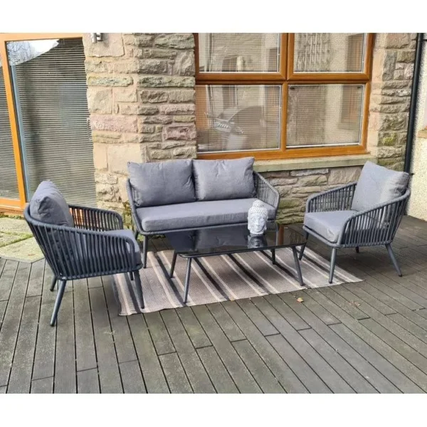 Grey 4 seater rope sofa set with cushions placed in a modern outdoor setting