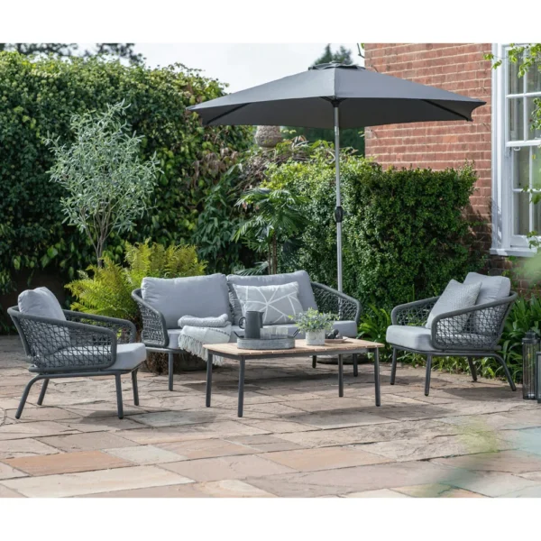 Grey 4-seater outdoor sofa set with cushions and matching table on a patio