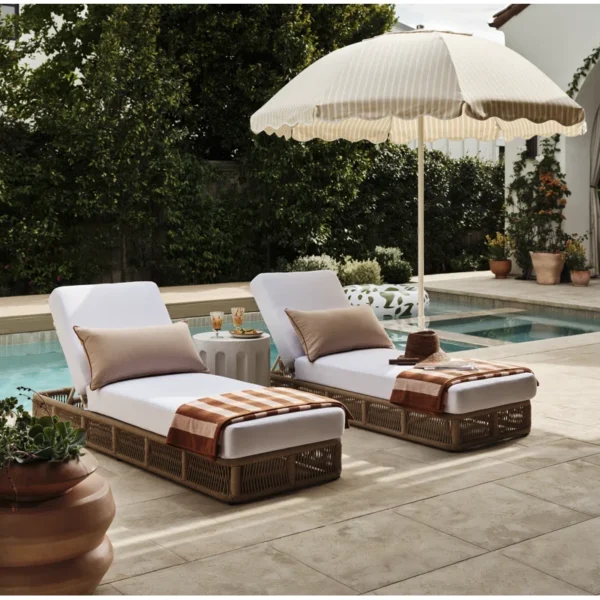Two beige rope sun loungers with plush white cushions, perfect for outdoor relaxation.