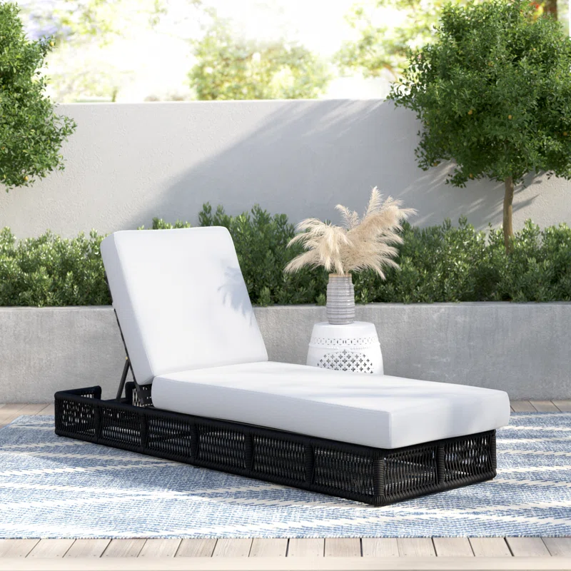 black rope sun lounger with soft white cushion for outdoor use.