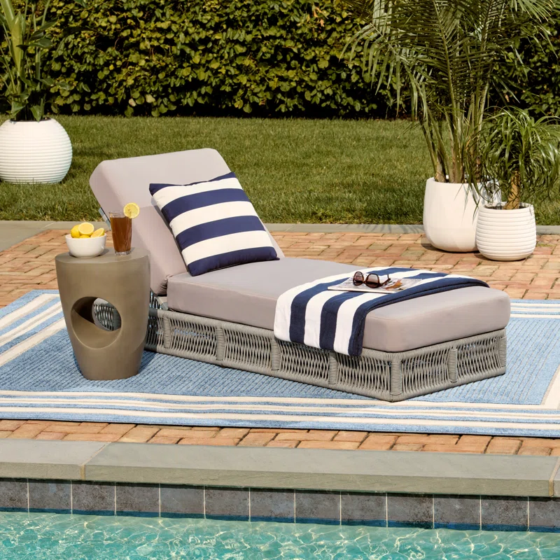 Grey rope sun lounger with soft grey cushion for outdoor use.
