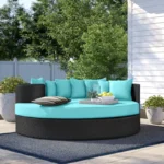 HDPE wicker outdoor patio daybed in dark brown frame with sky blue cushions, perfect for garden or balcony relaxation.