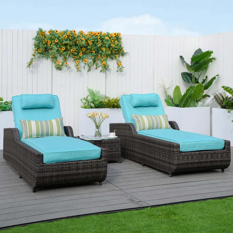 Dark brown rattan outdoor reclining chaise lounge with sky blue cushions.
