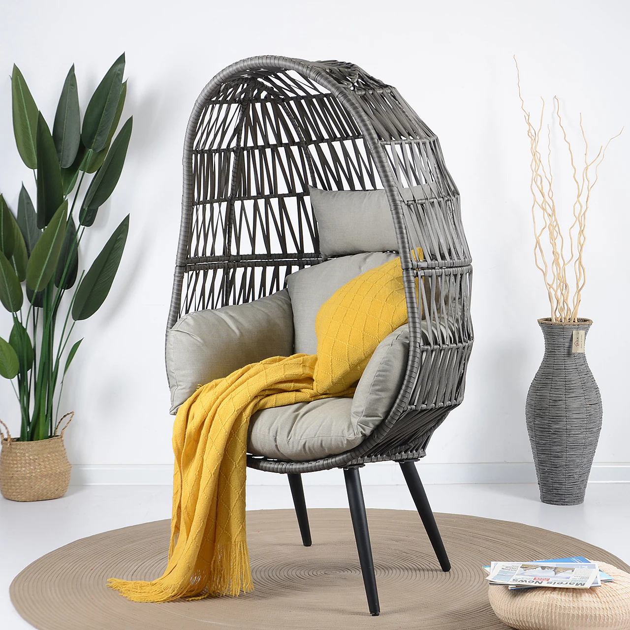 Single seater grey swing basket with sturdy frame, perfect for balcony or garden seating.