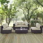 "4 pcs waterproof patio wicker furniture set with cushioned seats and glass-top table for outdoor spaces