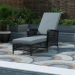 Adjustable outdoor chaise lounge wicker chair in black and grey with cushioned seating.