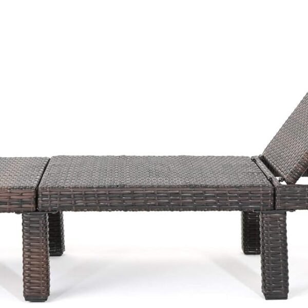 Resort-style outdoor lounge chair with green cushion, person reclining beside pool with palm trees and ocean view.